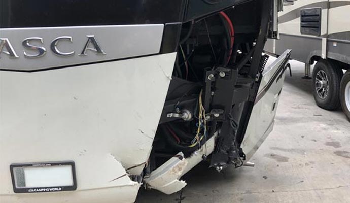 A close-up view of the front end of a damaged RV