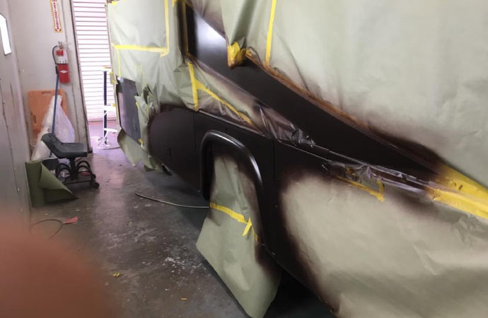 RV parked inside a garage being repainted.