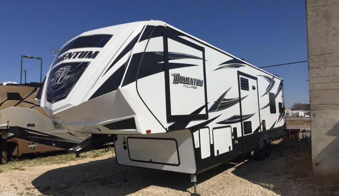 A mobile RV parked in a mechanical garage.