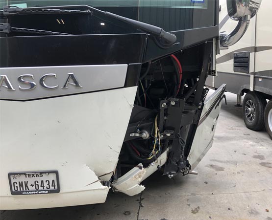 A damaged white and black RV 