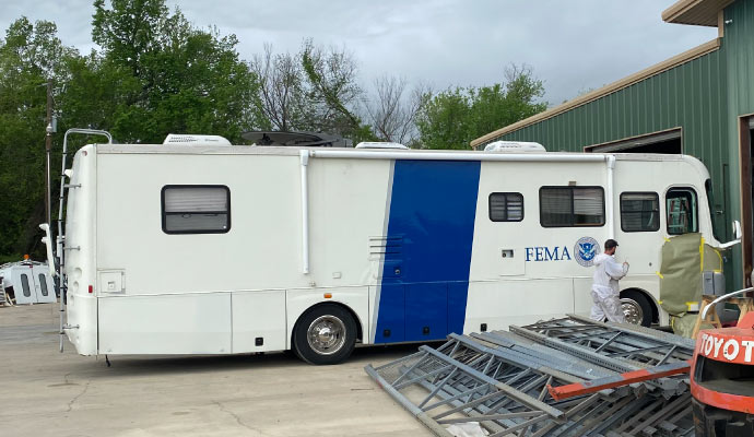 Person repairing RV siding Person repairing RV siding