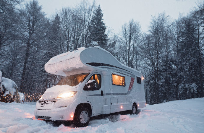 A White Rv van parked on snow